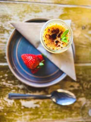 a bowl of food on a plate with a strawberry at The Crown Inn in Lanlivery