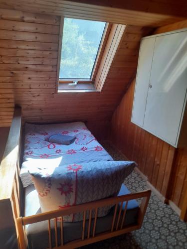 a small bedroom with a bed in a room with a window at Haus Guttenberg in Guttenberg