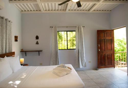 a bedroom with a large bed and a window at Casa Todo Bueno in Transito