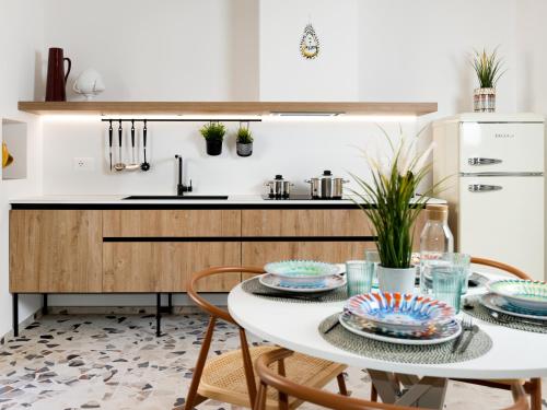 a kitchen with a table and chairs and a sink at Cally Suite Room in Martina Franca