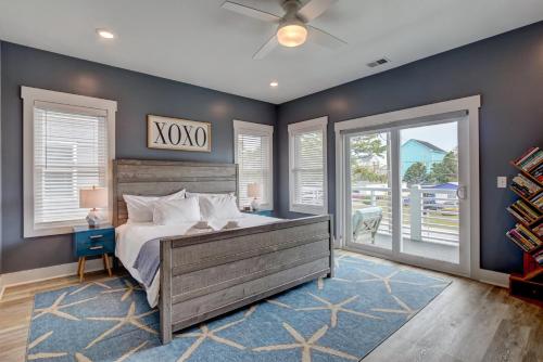 a bedroom with a bed and a ceiling fan at Oasis at the Beach in Carolina Beach
