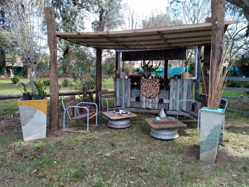 a gazebo with a table and chairs in the grass at Pualy Resort & Spa in Belén de Escobar