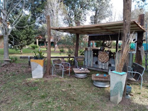 a gazebo with a table and chairs in a yard at Pualy Resort & Spa in Belén de Escobar