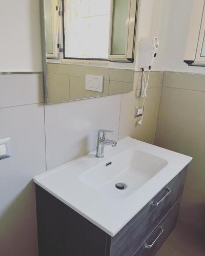 a bathroom with a white sink and a mirror at Le zagare in Palagiano