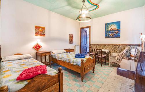 a bedroom with two beds and a table and chairs at B&B I Colori dell'Arcobaleno in Belvedere Langhe