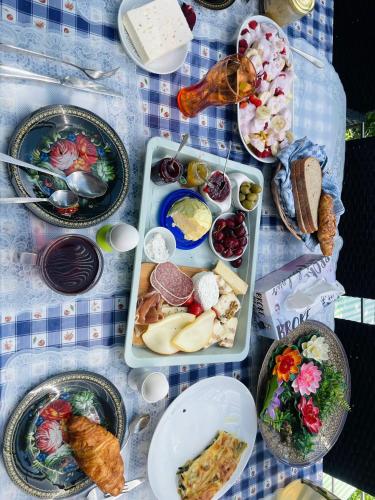 a table with plates of food on a table at Cozy room with a beautiful garden view in Baunatal