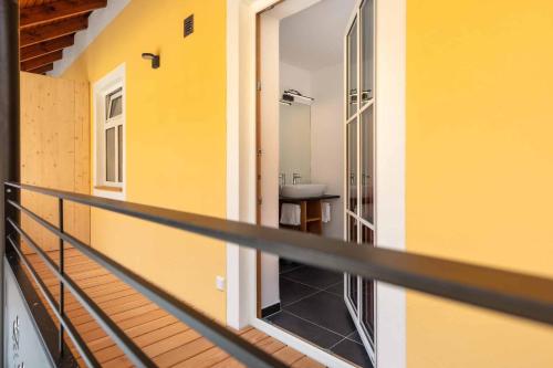 a balcony with a sink in a yellow building at Hotel Garni zum Schwan in Waldmünchen