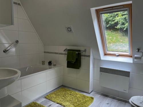a bathroom with a sink and a tub and a window at Palma Apartment 2 in Schottwien