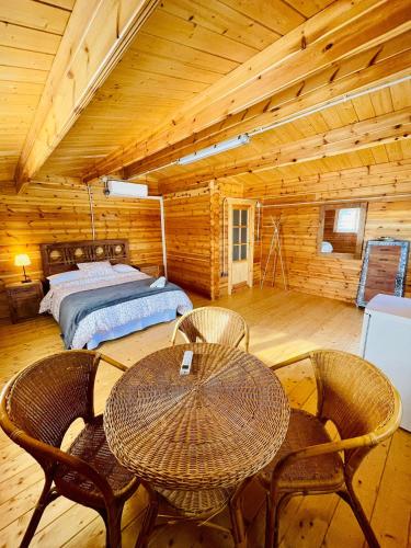 a bedroom with a bed and a table and chairs at El Bosque de Ribera in Escalona