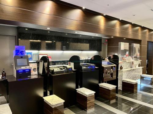 a lobby of a store with a cash register at APA Hotel Yodoyabashi Ekimae in Osaka