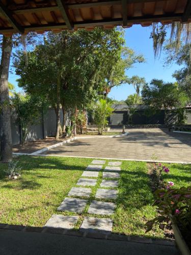 a walkway in a park with trees and grass at Pousada OCEAN in Saquarema
