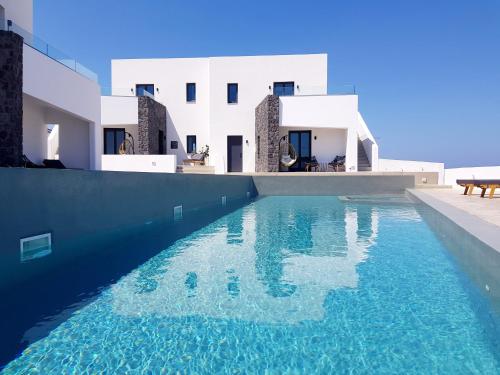 a swimming pool in front of a house at myLithos Suites in Monolithos