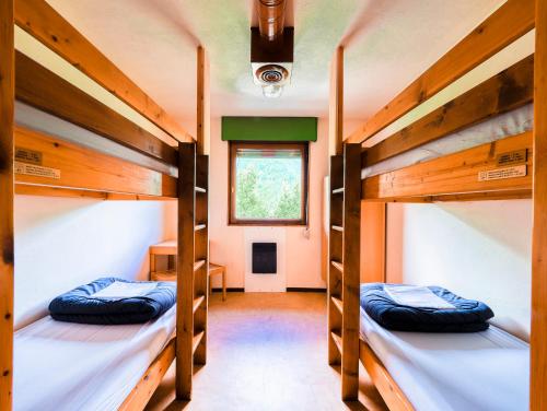Postel nebo postele na pokoji v ubytování Auberge de Jeunesse HI Chamonix