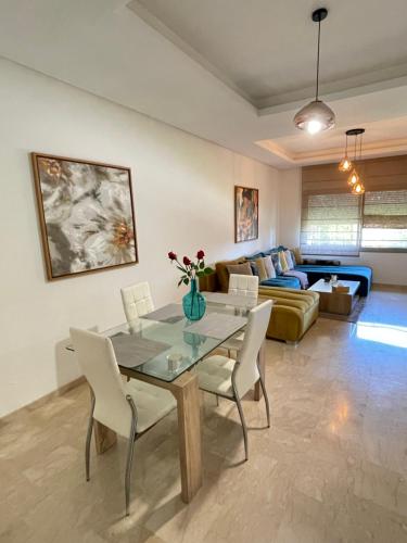 a living room with a table and chairs and a couch at BEST unit NEAR Casablanca AIRPORT in Casablanca