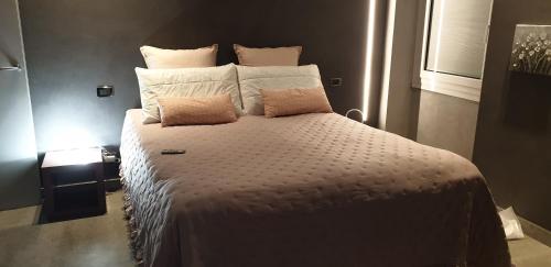 a bedroom with a large bed with white sheets and pillows at Il Vascello in Rapallo