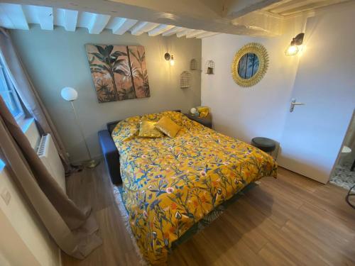 une chambre avec un lit avec une couverture jaune dans l'établissement Le studio jaune - studio hypercentre Rouen - 107, à Rouen