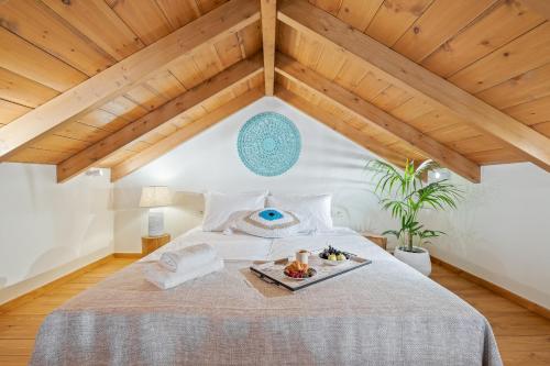 a bedroom with a bed with a tray of food on it at The Violin House in Chania
