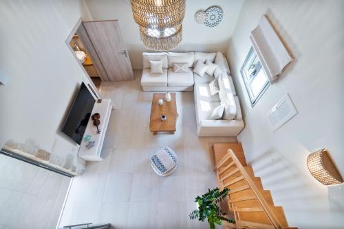 an overhead view of a living room with a couch and a tv at The Violin House in Chania