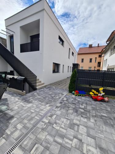 a house with a toy car in front of it at Apartment DINLUX in Maribor