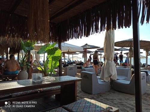a beach with chairs and tables and umbrellas at Diana's Penthouse in Perea