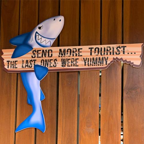 a sign that reads send more trust the last ones were yummy shark at Shark Town Mal Pais in Santa Teresa Beach