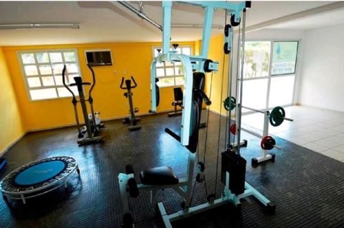 a gym with several exercise equipment in a room at Natal Prime Yacht Village in Natal