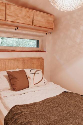 a bedroom with a bed and a window at Okno na las in Wola Polska