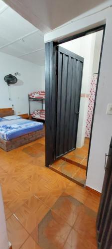 a room with a door and a bed in a room at HOTEL CASA COLONIAL in San Antonio del Táchira