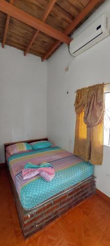 a small bed in a room with a window at HOTEL CASA COLONIAL in San Antonio del Táchira
