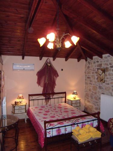 a bedroom with a bed and two tables in a room at Arhontiko Kordopati Traditional Guesthouse in Daras