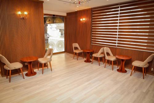 a room with wooden tables and chairs and a window at Grand Marino Hotel in Dubai