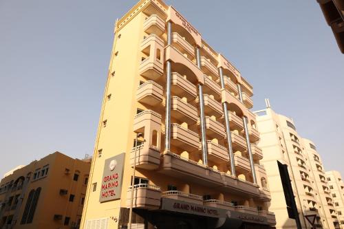 a tall building with a balcony on the side of it at Grand Marino Hotel in Dubai