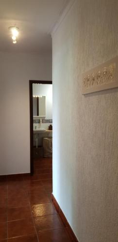a hallway with a room with a white wall at Quinta de Carvalhal - Casa de Campo in Guimarães