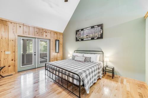 a bedroom with a bed in a room with wooden floors at Deer Run Retreat in Ellijay