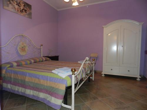 a bedroom with a bed and a white cabinet at Agriturismo Polla in Camporgiano