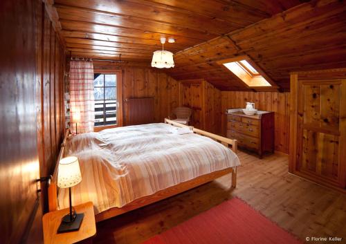 a bedroom with a bed in a wooden cabin at Les Soldanelles in Salvan