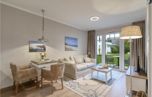 a living room with a couch and a table at Baltischer Hof Apartment 13 in Boltenhagen