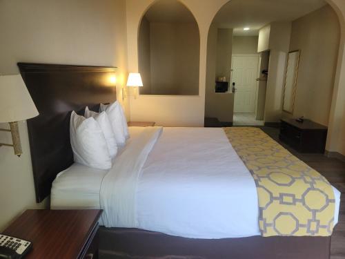 a hotel room with a large bed and a desk at Baymont by Wyndham Houston Brookhollow in Houston