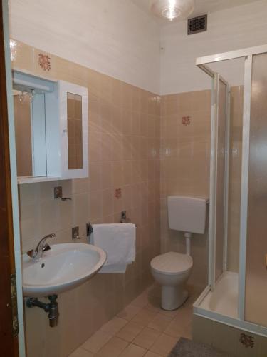 a bathroom with a sink and a toilet and a shower at Apartments for families with children Banjol, Rab - 16645 in Rab