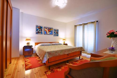 a bedroom with a bed and a table and a tv at Holiday house with WiFi Paz, Central Istria - Sredisnja Istra - 16623 in Buzet