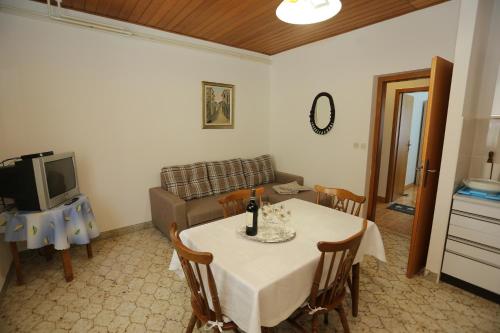 a living room with a table and a couch at Apartments with a parking space Supetar, Brac - 16807 in Supetar