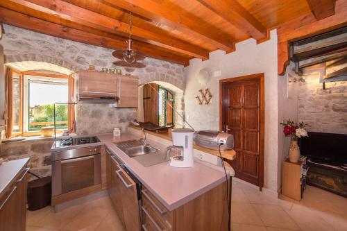 a kitchen with a sink and a counter top at Holiday house with a parking space Gornja Podgora, Makarska - 16835 in Podgora