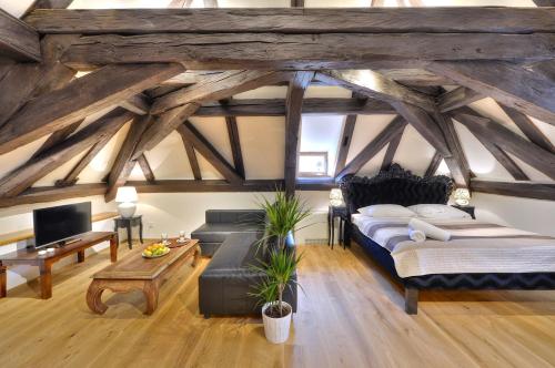 a living room with a bed and a couch at Old Town Boutique Apartments in Prague