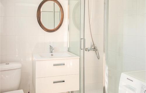 a bathroom with a shower and a sink and a mirror at Nice Apartment In Retowo 4 With 2 Bedrooms in Gardna Wielka