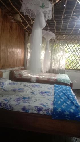 a wedding dress hanging in a room with a bed at mekong floating market Nam Giang homestay in Cai Be