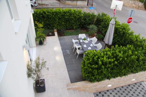 an overhead view of a patio with a table and an umbrella at Apartments by the sea Sveti Filip i Jakov, Biograd - 16966 in Sveti Filip i Jakov