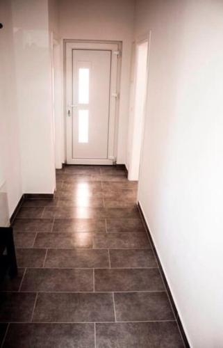 an empty hallway with a door and a tile floor at Apartments by the sea Sveti Filip i Jakov, Biograd - 16966 in Sveti Filip i Jakov
