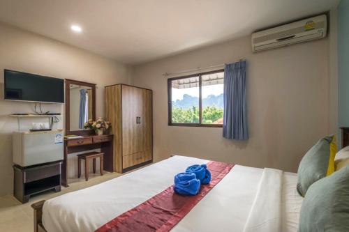 a bedroom with a bed with blue towels on it at Mookanda Residence in Ao Nang Beach