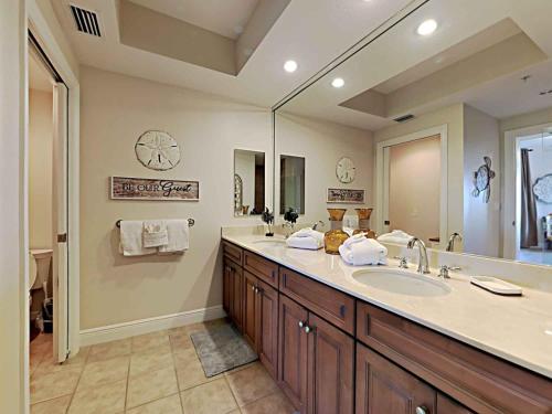 a bathroom with a sink and a large mirror at La Salbadora #402C at Lost Key in Perdido Key