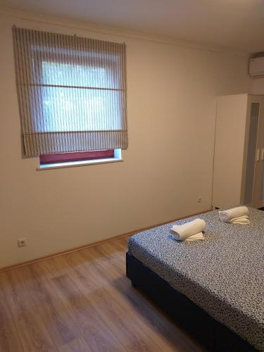 an empty room with a bed and a window at Double Room Njivice 17010a in Njivice